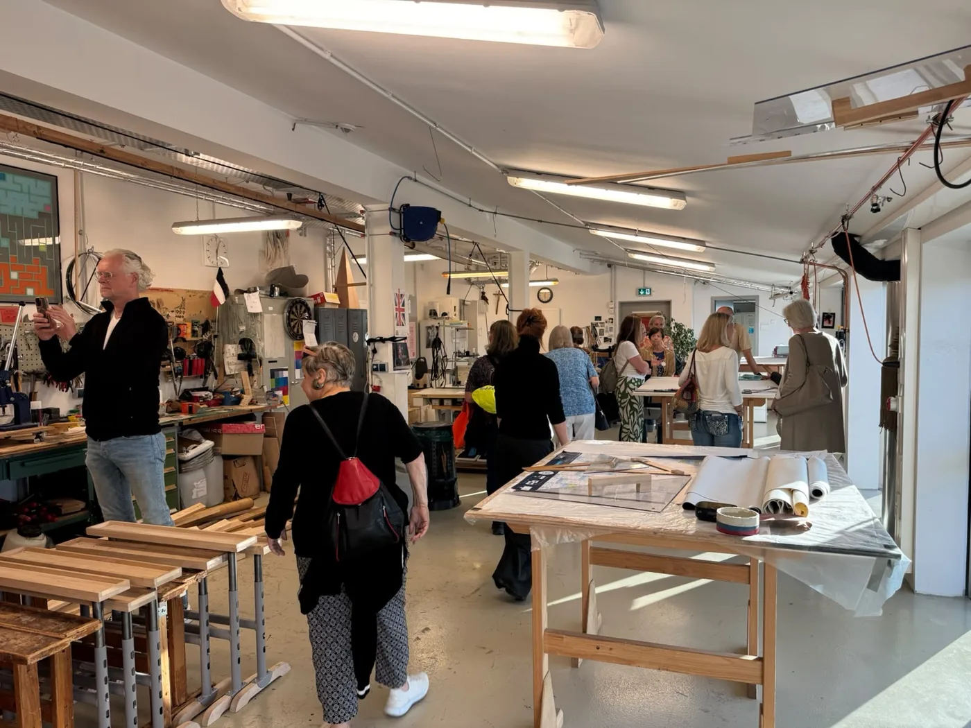 Besuchergruppe in der Tapezierwerkstatt des Staatstheaters am Gärtnerplatz während der Werkstattführung zu Die Reise nach Reims